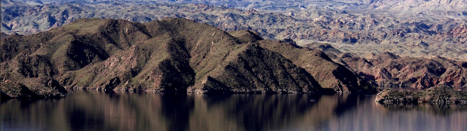 Arizona landscape of rounded hills with lake water in the foreground; used with permission