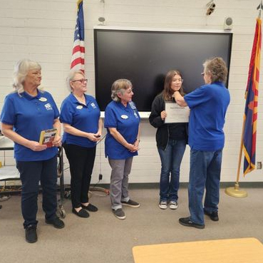 Photograph of three women watching a fourth woman presenting an award to a youth; JROTC outstanding cadet; photo taken by a chapter member and used with permission